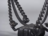 a metal sculpture of a horse with a chain around it ' s neck