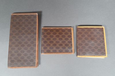 three pieces of brown and brown leather on a gray surface