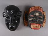 two masks that are sitting on a table