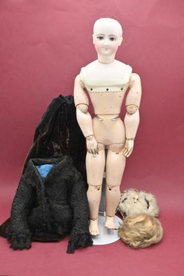 a mannequin and a teddy bear sitting next to each other