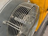 a fan that is sitting on the side of a yellow truck