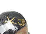 a black and white ball with a gold star on it