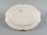 an image of a white plate on a stand on a gray surface