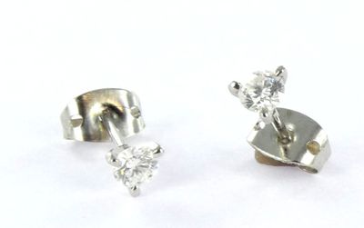 pair of diamond stud earrings on white background with white background