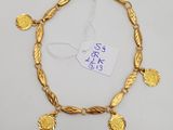 an image of a gold bracelet with coins on it