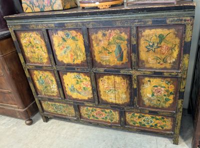 a wooden cabinet with many drawers and a basket on top of it