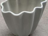 a white bowl sitting on the ground on the floor