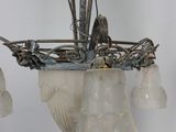 a chandelier that has a bunch of glass flowers hanging from it