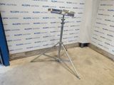 a microphone on a tripod in front of a wall