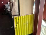 a refrigerator that is sitting in the corner of a room