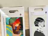 two bags with pictures of people on them sitting on a table