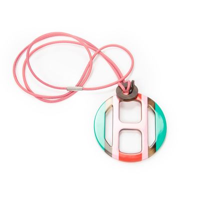 pink, green, and white necklace with a circular pendant on a pink cord