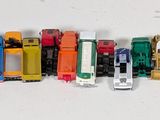 a lot of toy cars that are lined up on a table