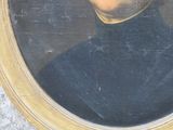 portrait of a man in a black shirt and a gold frame