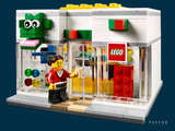 a lego store with a man standing in front of it