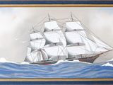 tableau représentant un voilier en mer par temps nuageux
