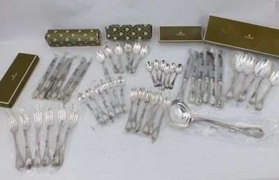 a lot of silverware sitting on a white table