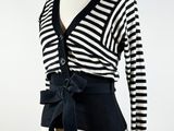 a black and white striped sweater with a bow tie on a mannequin mannequin