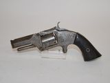 a close up of a gun on a white surface with a white background