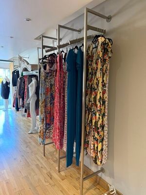 a lot of clothes hanging on a rack in a room