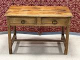an old wooden table with two drawers on top of it