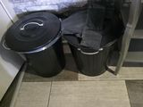 two trash cans sitting next to each other on the floor