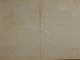 an old book with writing on it sitting on a table