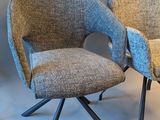 two chairs sitting next to each other on a white surface
