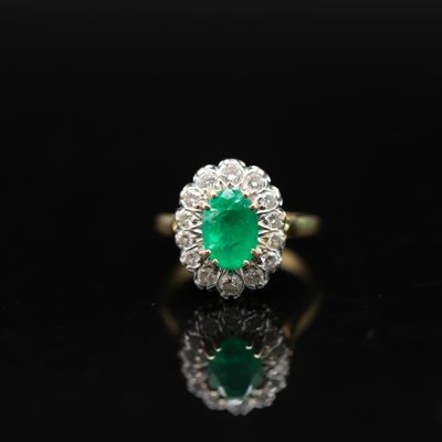 an emerald and diamond cluster ring