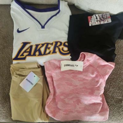 three t - shirts and pants are laid out on the floor