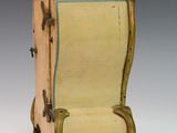 a small wooden chair that is sitting on a white surface