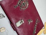 a red book sitting on top of a table covered in jewelry