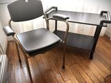a chair and a desk in the corner of a room