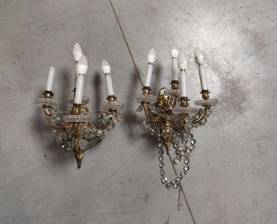 pair of crystal and brass sconces on a wall