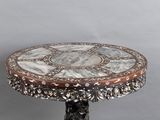 an image of a table with a marble top on a grey background