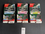 three boxes of game cards sitting on a table