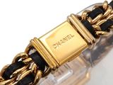 an image of a gold and black bracelet with a gold clasp