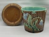 une tasse marron et bleue posée à côté d'un bol marron et blanc