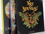 two books on a white table with a black cover and a picture of a butterfly