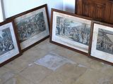 three framed pictures on the floor of a room
