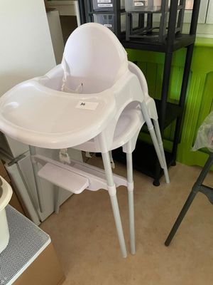 a baby high chair in the corner of a room