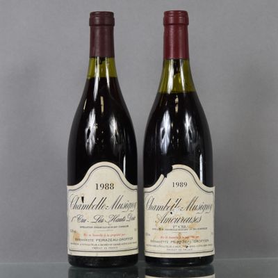 two bottles of wine sitting on top of a table next to each other
