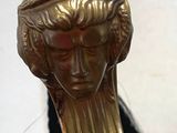 a gold statue of a woman with long hair