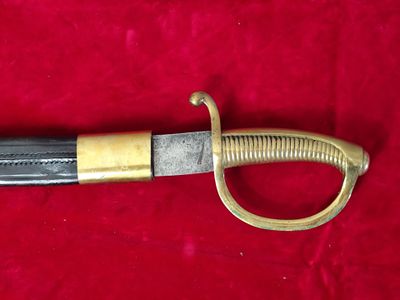 a close up of a sword on a red cloth