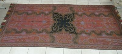 un tapis posé au sol, orné d'un motif de papillon