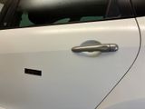 a close up of a car door handle with a sticker on it