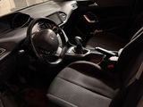 the interior of a car with the door open and the driver ' s seat down