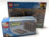 two lego city sets are sitting next to each other on a white surface