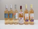 several bottles of wine are lined up on a table