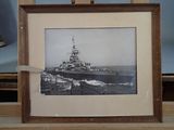 a picture of a ship in a frame on a table